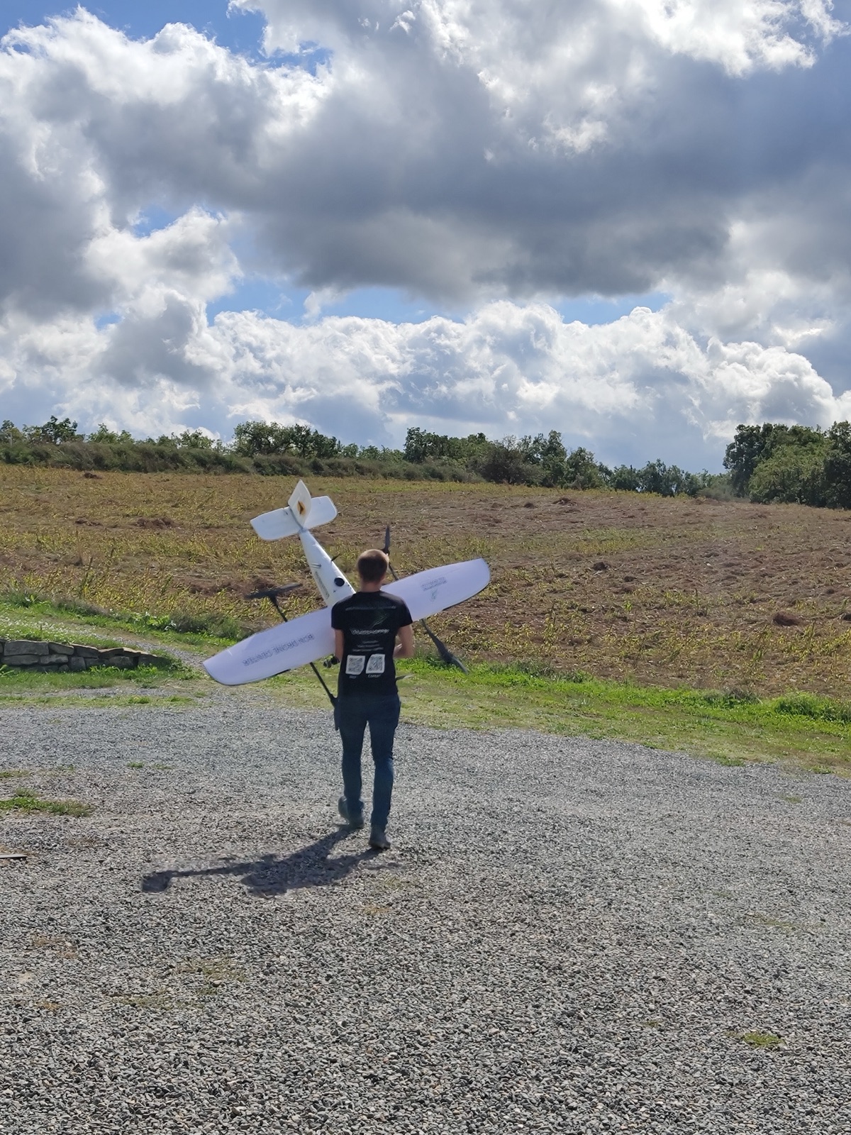 Jakob Saalfrank carrying the proof-of-concept aircraft out to the strip on the morning of the first flight.